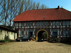 a house with two cars parked in front of it at Domäne Paterhof in Duderstadt