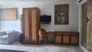 a living room with a couch and a chair at Apartment Nine at the Bayshore Resort Candidasa in Candidasa