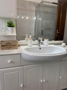 a white bathroom with a sink and a mirror at L'appartamenDino in Poggio Mirteto +22 photos