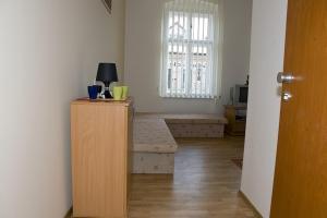 a living room with a bench and a window at Hyde Park Hostel in Bratislava