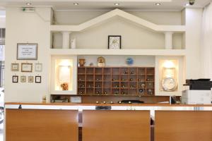 a large room with a desk and a wall of cabinets at Athens Delta Hotel in Athens