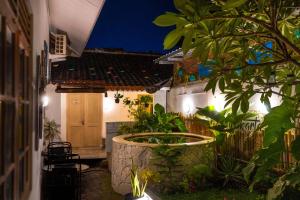 a courtyard of a house at night at Wonderloft Hostel Jogja in Yogyakarta
