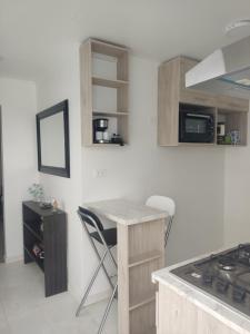 a kitchen with a counter and a table with chairs at cabañas los flamencos A in Punta Arenas