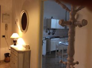 a kitchen with a table and a cross in a room at Intorno Firenze B&B in San Piero a Sieve