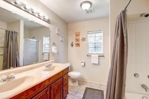 a bathroom with a sink and a toilet and a mirror at Seashell Memories in Rockport +40 photos