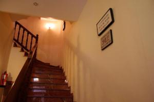 a staircase in a building with two pictures on the wall at Pensión Argüelles in Ribadesella