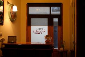 a room with a window with a sign on it at Pensión Argüelles in Ribadesella