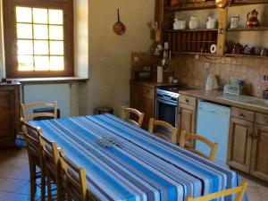 a kitchen with a blue and white table and chairs at Gîte historique au château de charme proche du Mans - FR-1-410-453 in Saint Pavace +11 photos