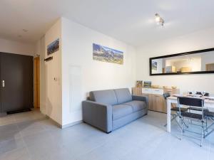 a living room with a couch and a table at À Loudenvielle, T2 moderne, proche télécabine, parking, wifi - FR-1-695-61 in Loudenvielle