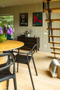 a dining room with a table and chairs at Māja Klusumā in Jaunķempji