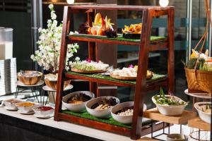 a display of food on a shelf with dishes at The Marina Phuket Hotel in Patong Beach