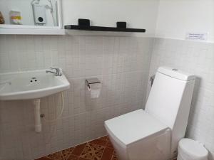 a white bathroom with a toilet and a sink at Khaolak Banana Bungalow in Khao Lak +55 photos