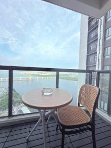 a table and two chairs on a balcony with a view at R&F Seine Region at ANJU in Johor Bahru