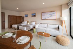 a living room with a couch and a table at Everglades Suites in Cancún +45 photos