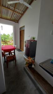 ein Wohnzimmer mit Fernseher und Tisch in der Unterkunft Jungle Beach Inn in Unawatuna