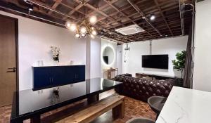 a waiting room with a couch and a television at Brown Brick Thonglor - Blue Blueberry Room in Klong Toi