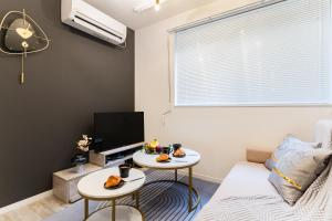 a living room with two tables and a tv at #1 -高田馬場アネックス- Condo in Tokyo