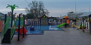 an empty playground with a pool and slides at Villa Wanie Cottage in Setiu