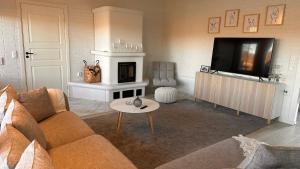 a living room with a couch and a tv at Villa Sofia In Lapland in Tornio
