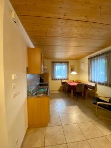 a kitchen and dining room with a table at Oberprantschöllhof - Horse Mountain Stable in Bressanone