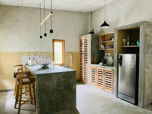 a kitchen with a counter and a refrigerator in it at The Traveller Kandy in Kandy