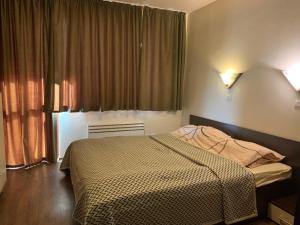 Postel nebo postele na pokoji v ubytování Sunrise Apartment Pamporovo + 19 fotografií