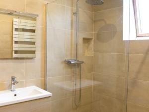 a shower with a glass door next to a sink at Gîte historique au château de charme proche du Mans - FR-1-410-453 in Saint Pavace