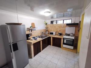 a kitchen with a refrigerator and a stove top oven at maison de ville in Saint-Denis