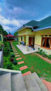 a house with a garden in front of it at Restu adel in Cisarua