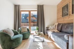 a living room with a couch and two chairs at Apres Ski Bachleda - LoftAffair Collection in Zakopane
