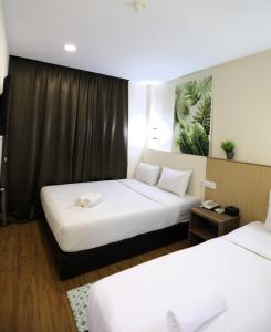 Postel nebo postele na pokoji v ubytování ECO Hotel at BBCC