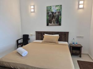 a bedroom with a large bed and a chair at Jays Apartment Colombo 05 in Colombo +35 photos