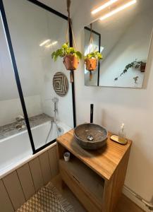 a bathroom with a sink and a bath tub at Chambre et salle de bain privée in Santes