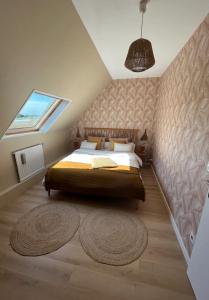 a bedroom with a bed and a window and a rug at Chambre et salle de bain privée in Santes