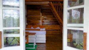 a room with a bed and two windows at Dins Nature Villa in Elgiriya