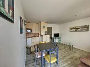 a kitchen and dining room with a table and chairs at La Bolee d Air in Quiberon