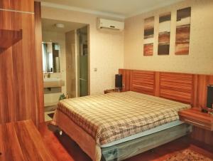 a bedroom with a bed and a sink and a mirror at Ancol Mansion Apartment Sea View by Berlin Village in Jakarta +13 photos