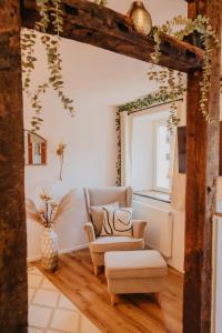 a living room with a chair and a couch at JASTA Homes Mosel, zentral, Netflix, Waschmaschine, Terrasse, Privateingang, Erdgeschoss, ältester Weinort Deutschlands in Neumagen-Dhron