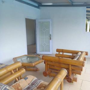 a room filled with wooden logs and a glass table at Karibik Ocean view Guesthouse Trinidad in Las Cuevas +43 photos