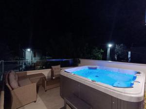 a jacuzzi tub on a patio at night at Villa Exopoli in Georgioupolis