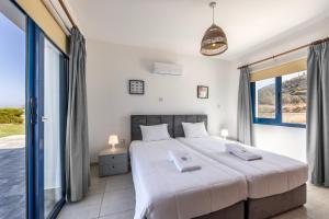 Postel nebo postele na pokoji v ubytování Diana Seaside Villas