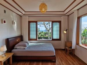 Ένα ή περισσότερα κρεβάτια σε δωμάτιο στο Stone Stay Seongsan