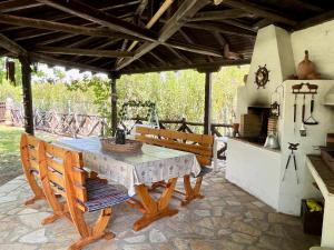 a patio with a table and benches on a patio at Stone Villa Rokosini in Vourvourou