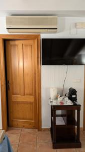 a room with a table and a television and a door at Casa Rosa in Alcalalí +46 photos