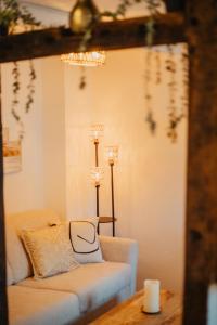 a living room with a couch and a table at JASTA Homes Mosel, zentral, Netflix, Waschmaschine, Terrasse, Privateingang, Erdgeschoss, ältester Weinort Deutschlands in Neumagen-Dhron