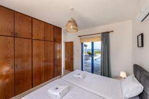 Postel nebo postele na pokoji v ubytování Diana Seaside Villas