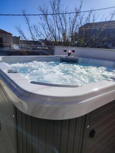 a hot tub with water and two glasses of wine at Villa Exopoli in Georgioupolis