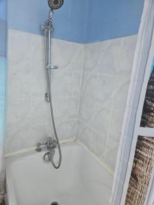 a shower with a shower head in a bathroom at Chambre d'hôte à coté de la voie verte in Gourin +12 photos