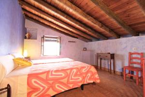 a bedroom with a large bed and a wooden ceiling at Casa de la Jara by SIERRA VIVA in La Nava