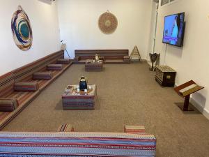 a room with couches and a tv in a building at Legacy Hostel in Muscat